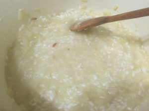 Stirring wine into risotto rice for Risotto @ bestwithchocolate.com