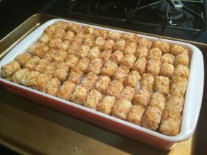 Topping the dish with tater tots for Tater Tot Hot Dish @ bestwithchocolate.com