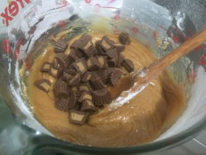 Adding in reese's cups to the bar dough for Triple Peanut Butter Bars @ bestwithchocolate.com