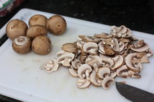Slicing mushrooms for Goat Cheese Mushroom Pasta @ bestwithchocolate.com
