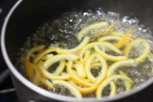 Action shot of boiling the peel for Candied Orange Peel @ bestwithchocolate.com