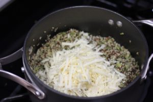 Adding cheddar cheese to Broccoli Cheddar Quinoa @ bestwithchocolate.com