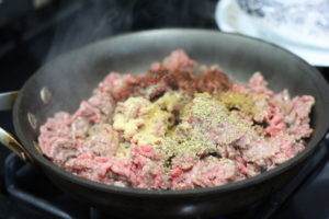 Adding seasonings to ground beef for Black & Blue Sliders @ bestwithchocolate.com