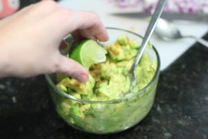Adding lime to Guacamole @ bestwithchocolate.com