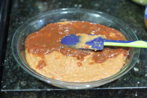 Layering salsa over refried beans for Five Layer Dip @ bestwithchocolate.com