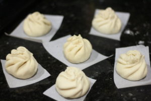 Folding up dough for Nikuman (Steamed Pork Buns) @ bestwithchocolate.com