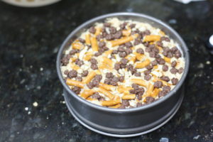 Topping Peanut Butter Crunch Pie with crunch pieces and pretzels @ bestwithchocolate.com