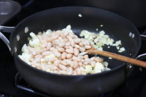 Adding beans for Vegetarian Samosa Burritos @ bestwithchocolate.com