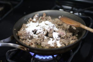 Adding flour to sausage for Biscuits & Sausage Gravy @ bestwithchocolate.com
