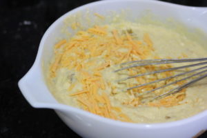 Adding cheese to the Mexican Corn Bread Batter @ bestwithchocolate.com