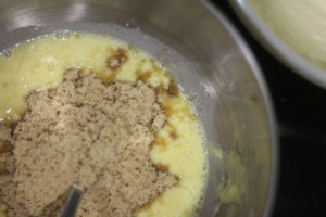 Adding in brown sugar to batter for Coconut Milk Banana Bread @ bestwithchocolate.com