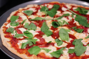 Top proscuitto burrata arugula pizza with arugula @ bestwithchocolate.com