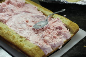 Adding the ice cream filling to Strawberry Crunch Ice Cream Cake @ bestwithchocolate.com