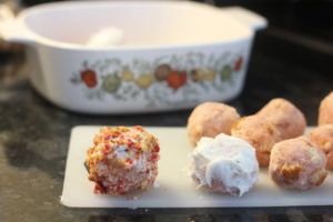 Icing the Strawberry Crunch Cakeballs @ bestwithchocolate.com