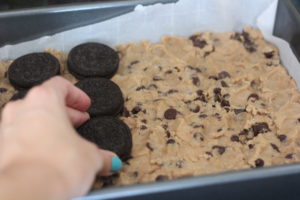 Adding Oreo layer for Slutty Brownies @ bestwithchocolate.com