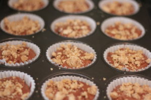 Adding crumbles to the top of Peanut Butter Chip Muffins @ bestwithchocolate.com