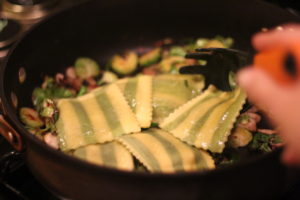 Tossing ravioli into pan for Buttery Brussel Sprouts and Ravioli @ bestwithchocolate.com