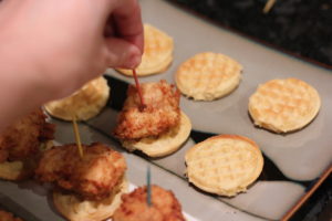 Stickin toothpicks in Chicken and Waffle Sliders @ bestwithchocolate.com
