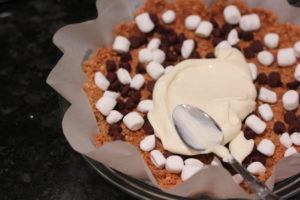 Spreading cheesecake filling for S'mores Cheesecake @ bestwithchocolate.com