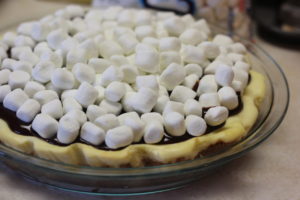 Adding marshmallow topping to S'mores Cheesecake @ bestwithchocolate.com