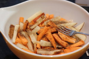 Adding seasoning to soaked fries for Loaded Whole30 Fries@ bestwithchocolate.com
