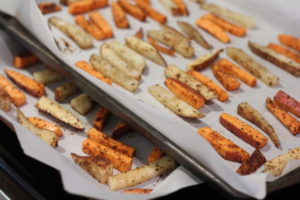 Sliced fries tossed in seasoning and ready to bake for Loaded Whole30 Fries@ bestwithchocolate.com