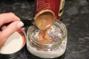 Adding almond butter to Banana Almond Butter Chia Seed Pudding @ bestwithchocolate.com