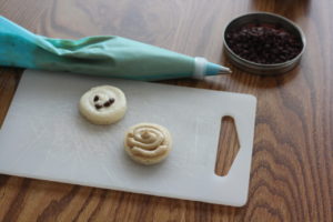 Adding cookie dough icing filling for Chocolate Chip Cookie Macaroons @ bestwithchocolate.com