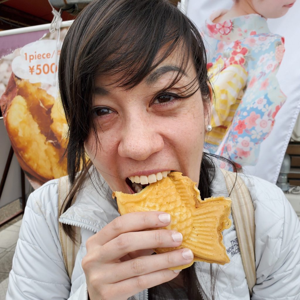 Me happily stuffing my face with taiyaki, a warm custard pastry @ bestwithchocolate.com