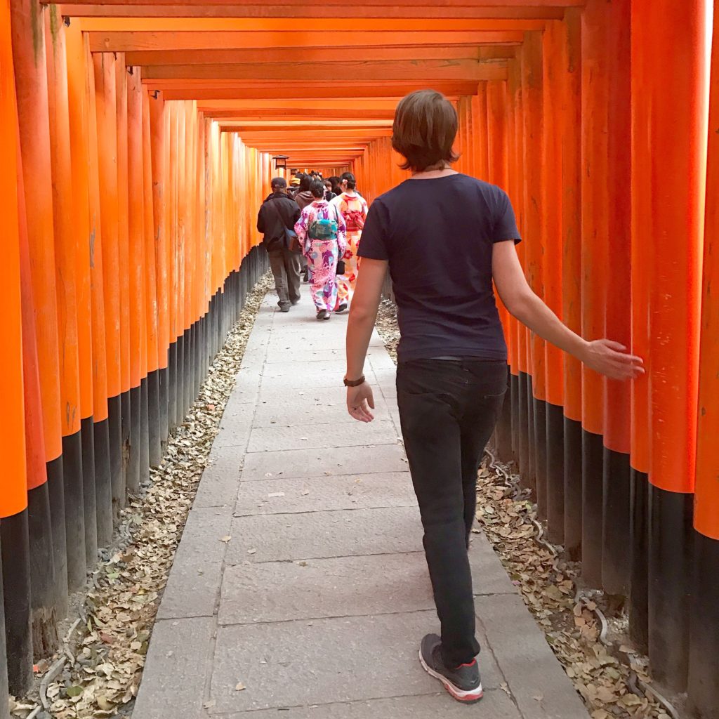 Tyler walking through the gates at Fushimi Inari-Taisha @ bestwithchocolate.com