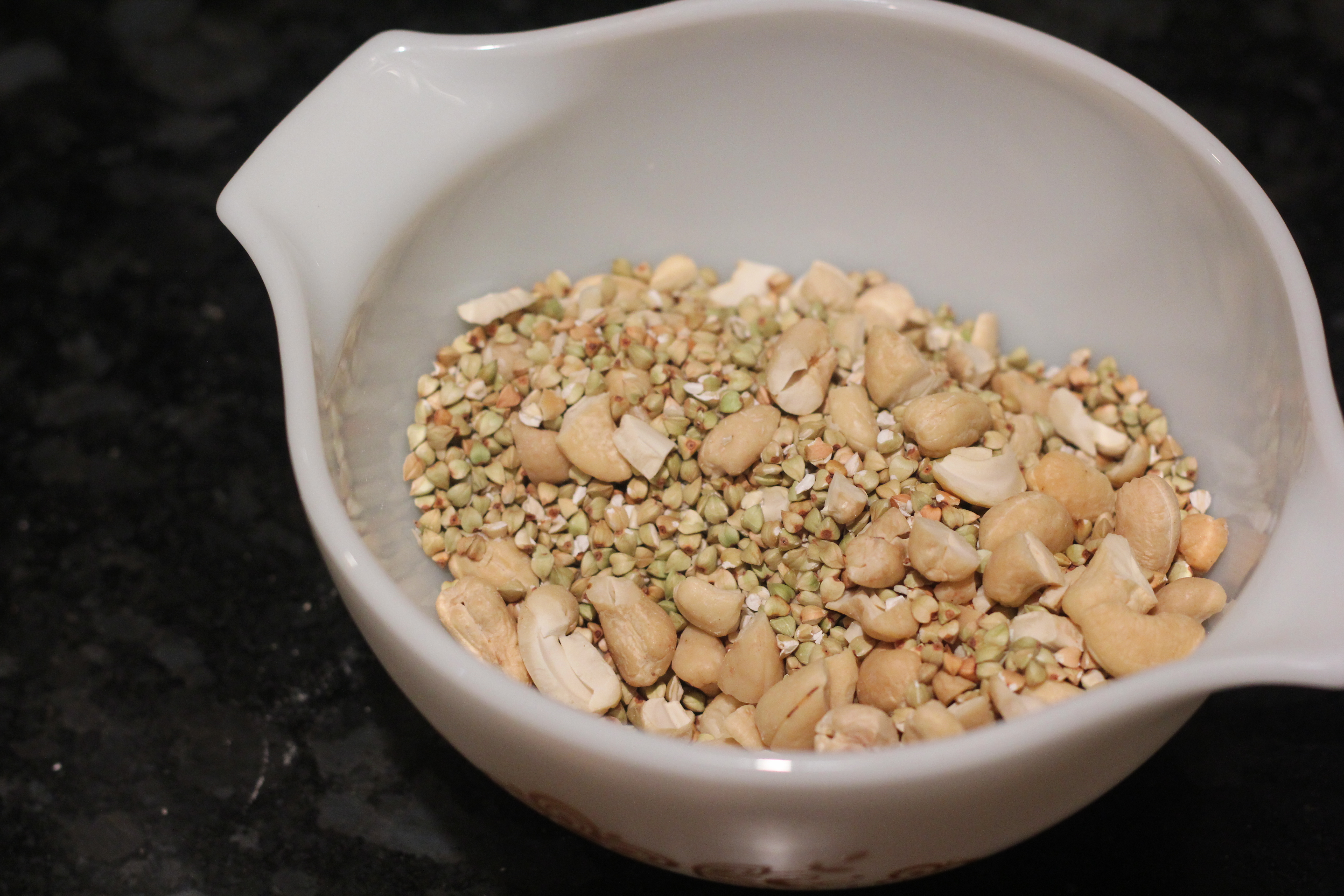 Adding chopped cashews to Buckini Granola Bars @ bestwithchocolate.com