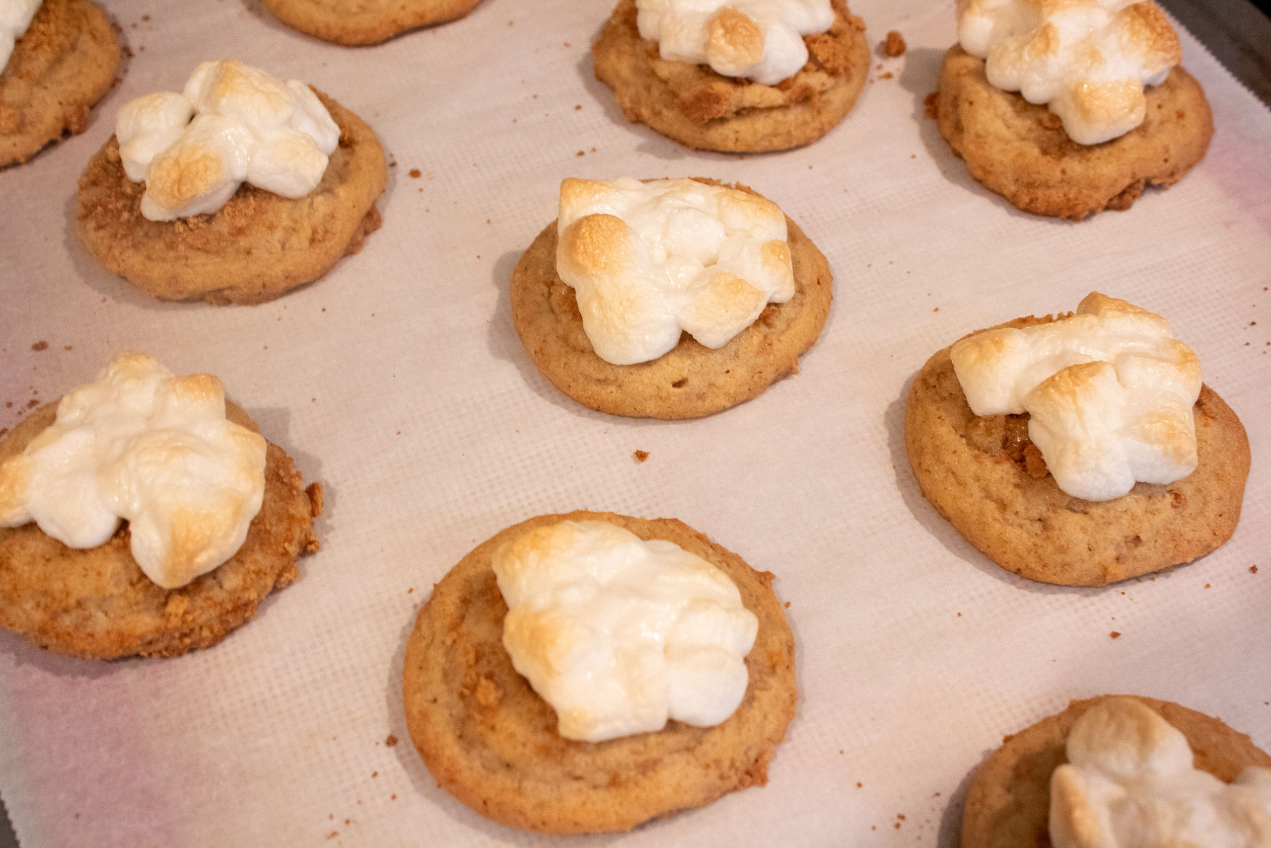 Freshly toasted marshmallows on top of freshly baked S'mores Kiss Cookies @ bestwithchocolate.com