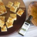 Foccia cubes cut from the loaf, with a small olive oil dish and bottle for dipping
