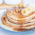 Healthful Greek Yogurt Pancakes with bananas and walnuts and syrup