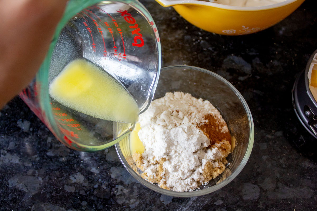 Adding butter to ingredients for crumble for Peach Bourbon Mini Cheesecakes @ bestwithchocolate.com