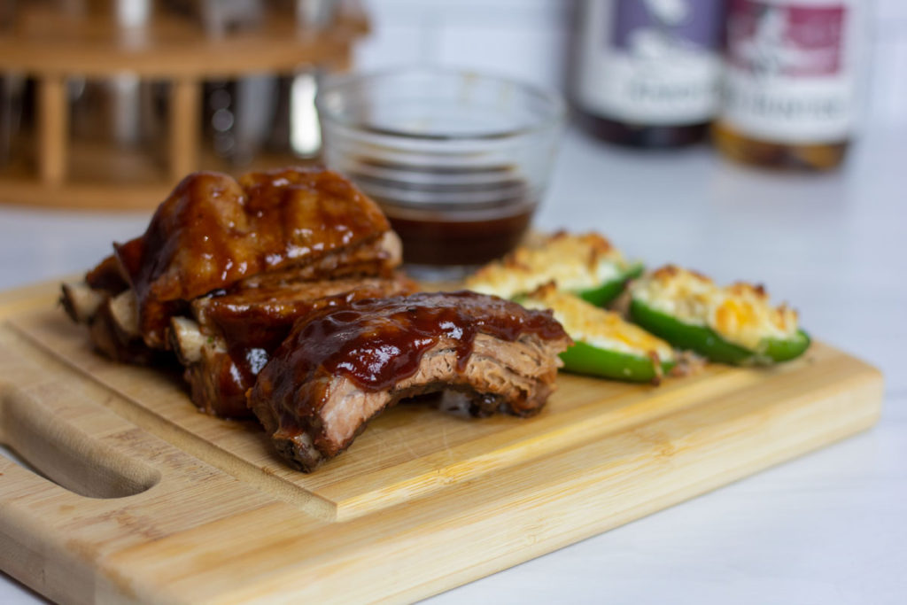 Slow cooker baby back ribs on a wooden cutting board