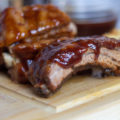 Slow cooker barbecue baby back ribs on a wooden cutting board