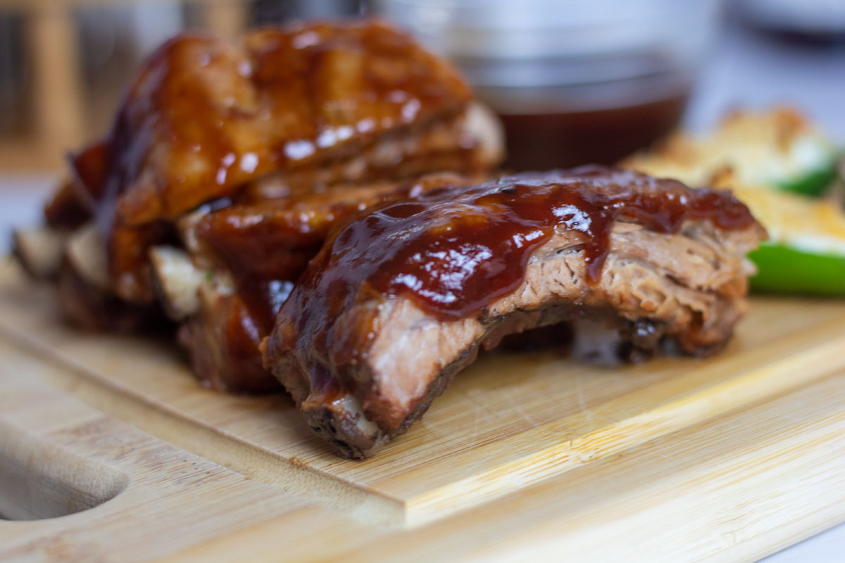 Slow cooker barbecue baby back ribs on a wooden cutting board