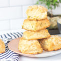sour cream and chive biscuits stacked on a plate