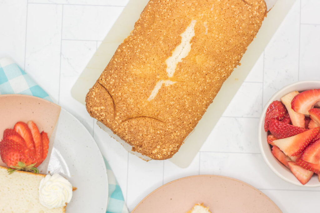 Angel food cake loaf among assorted plates and dishes