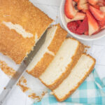 Knife slicing a loaf of angel food cake