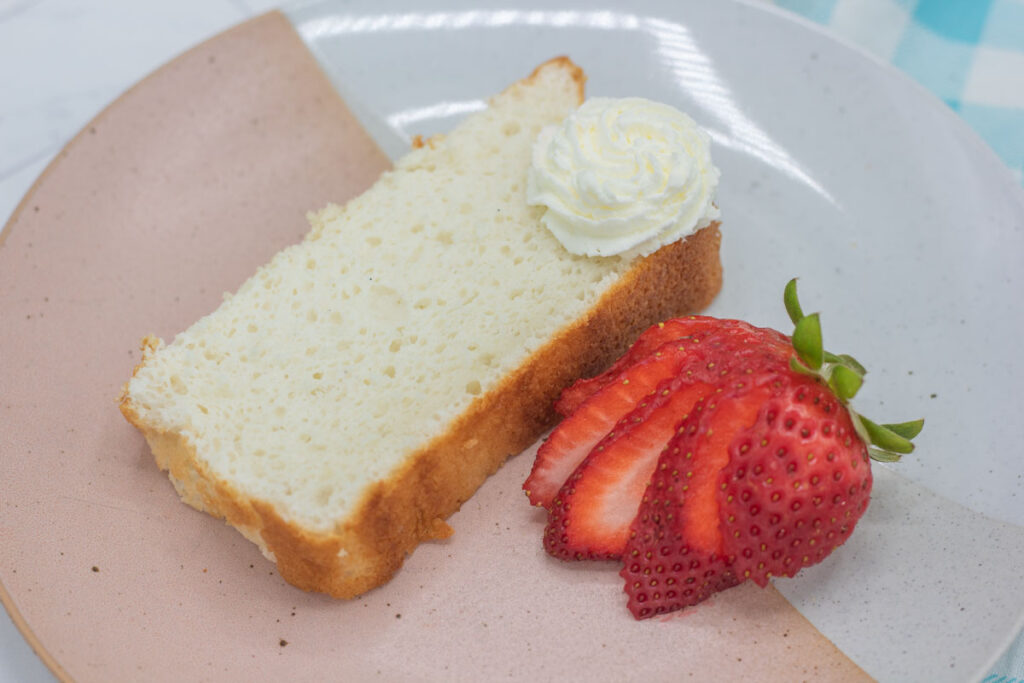 A simple slice of angel food cake and strawberries