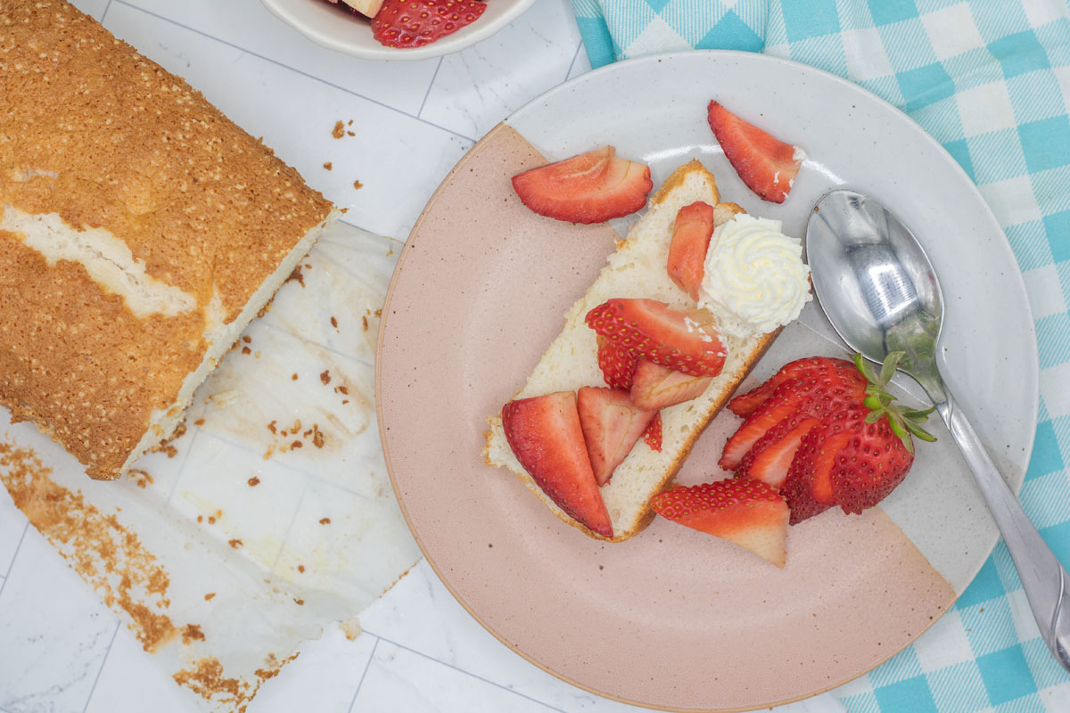 Chopped strawberries tossed over a slice of angel food cake loaf
