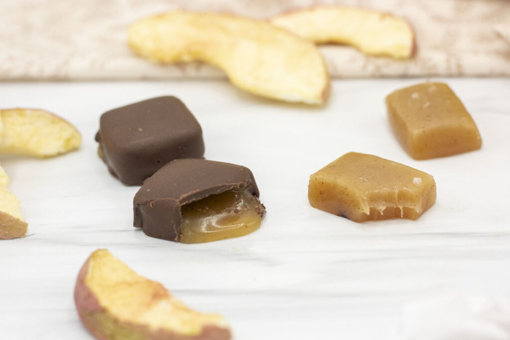 Chocolate covered and bare apple cider caramels