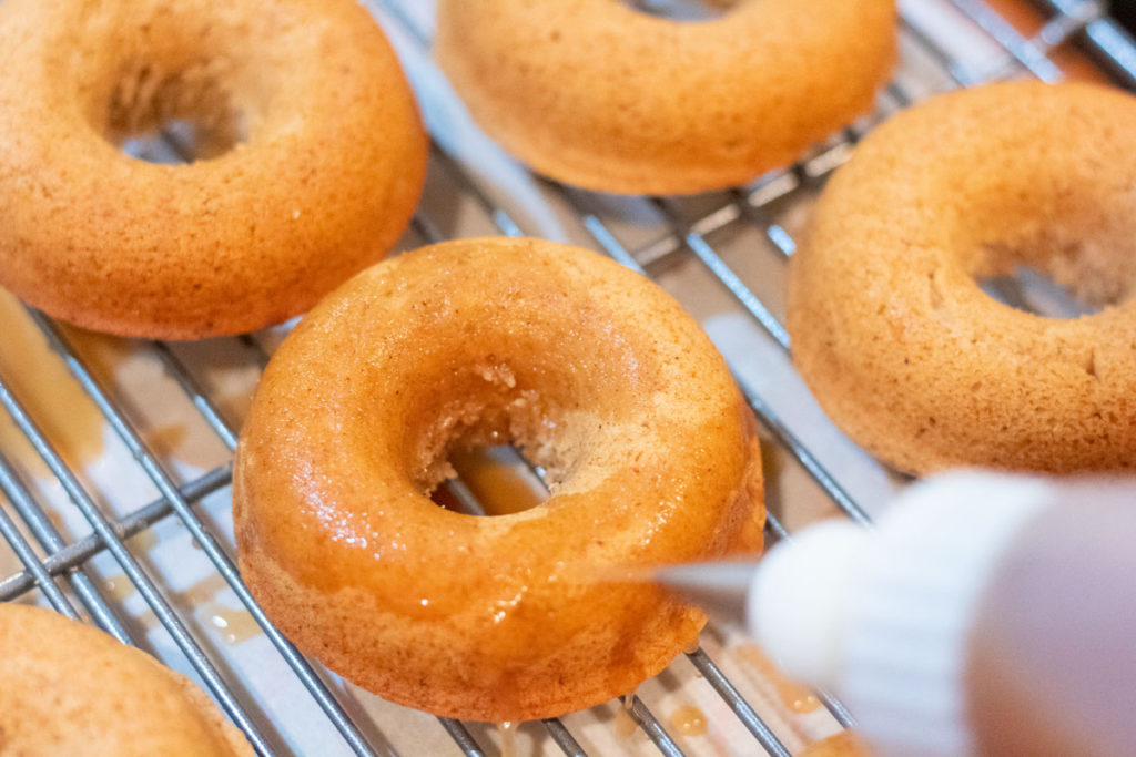Coating apple cider doughnuts with apple cider reduction