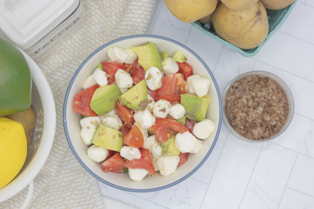 A bowl of avocado caprese salad and smoked salt