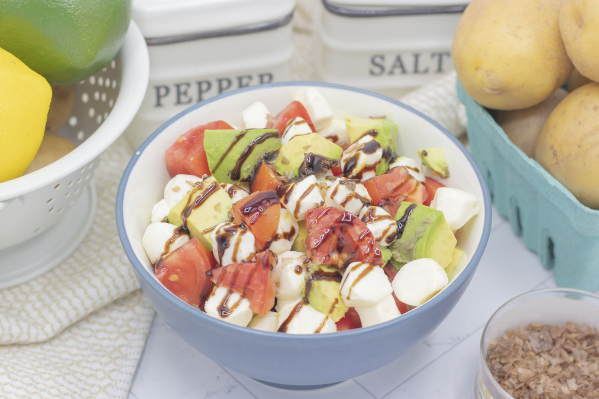 Avocado caprese salad with a drizzle of balsamic glaze