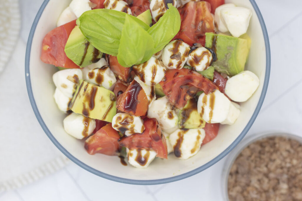 Avocado caprese salad with basil and balsamic glaze