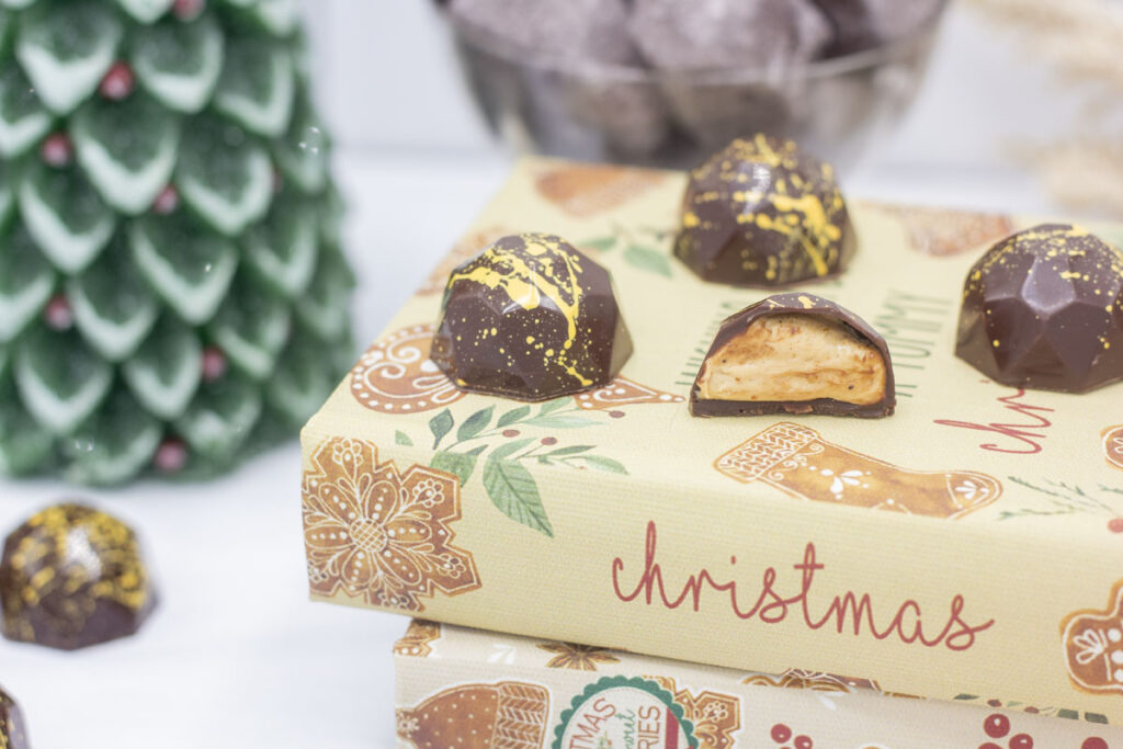 Easy no bake nougat truffles on stack of Christmas books