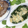 View of blue cheese creamed spinach next to steaks;